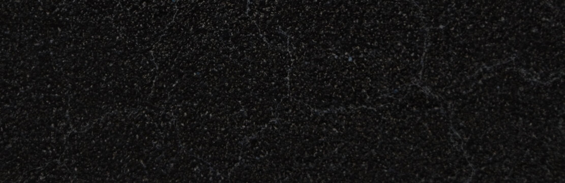 Black granite texture background, dark charcoal marble stone surface with natural veins, elegant matte basalt rock finish for luxury interior design