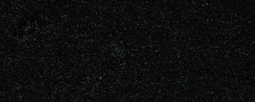Black granite texture background, dark polished stone surface with natural white speckles, elegant marble slab material for luxury interior design