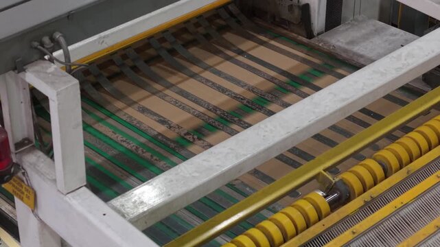 Industrial machine operating with rollers. Machinery, assembly line, manufacturing, factory, production, industrial automation