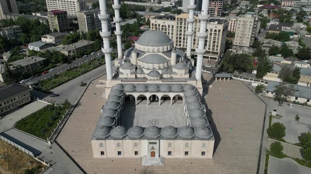 Aerial view of the Imam Sarakhsi Central Mosque featuring its large dome, tall minarets, and courtyard in Bishkek, Bishkek City, Kyrgyzstan.