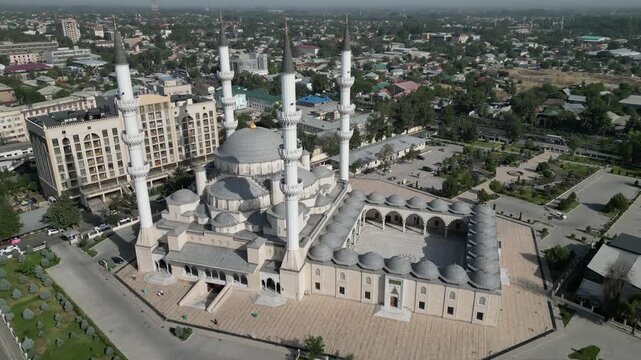 Aerial view of the Imam Sarakhsi Mosque featuring its four tall minarets and large central dome, surrounded by the urban landscape of Bishkek, Bishkek City, Kyrgyzstan.