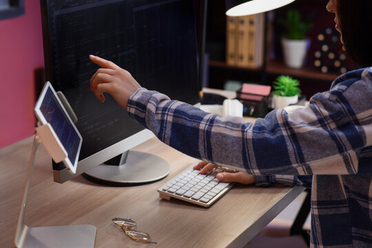 Female programmer working with computer at table in office