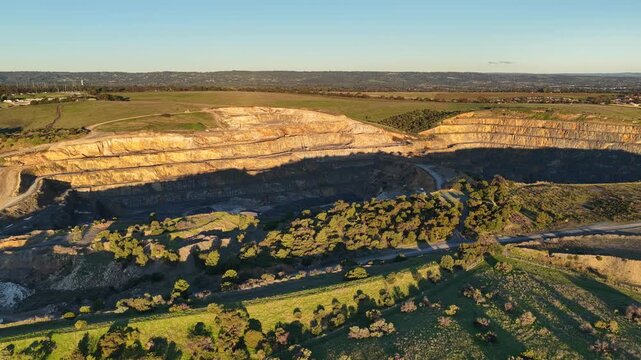 Marino, Adelaide, South Australia &ndash; 4K aerial drone footage of Linwood Quarry, limestone extraction, hard rock aggregates, terraced quarry walls, mining operation between Seacliff Park, Hallett Cove