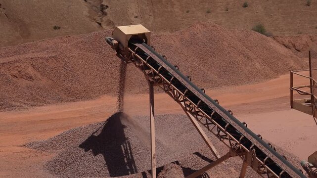 Industrial Conveyor Depositing Crushed Stone Onto a Growing Aggregate Stockpile