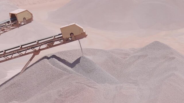 Industrial Conveyors Depositing Crushed Stone Onto Massive Quarry Stockpiles