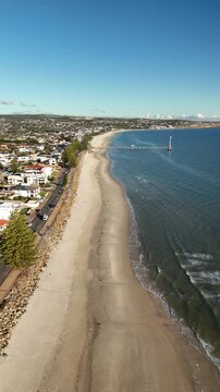 Brighton Beach, Adelaide, South Australia: 4K Vertical Aerial Drone Footage of Coastline, Turquoise Ocean, Sandy Beach, Jetty, Coastal Suburbs, Residential Houses, Estates, Parkland, Scenic Shoreline.