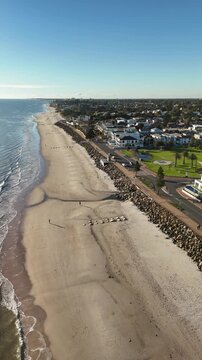 Brighton Beach, Adelaide, South Australia: 4K Vertical Aerial Drone Footage of Coastline, Turquoise Ocean, Sandy Beach, Jetty, Coastal Suburbs, Residential Houses, Estates, Parkland, Scenic Shoreline.