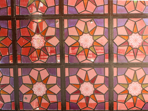 Part of a stained-glass window featuring decagrams ten-pointed stars symbolizing the divine, the balance between spirit and matter, and wholeness in Curitiba, Paran&aacute;, Brazil.
