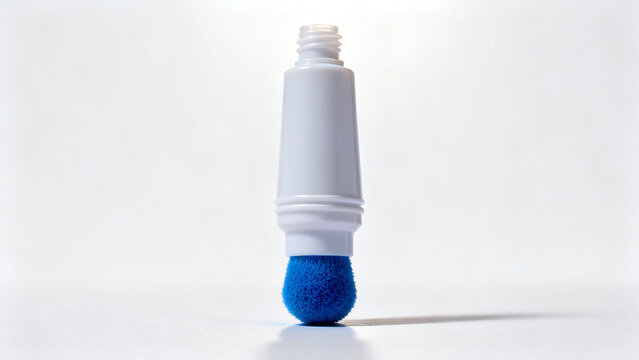 A white bingo dauber marker with a blue sponge tip standing upright on a clean white surface background.