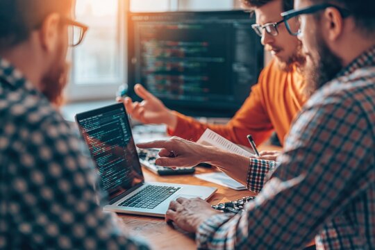 Software development team working on coding and collaboration in a modern office