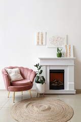 Obraz premium Interior of stylish living room with paintings, armchair and fireplace