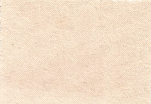 Bright clean pale peach cream handmade cotton rag paper texture with fine surface grain and tiny rustic imperfections. Beautiful luxury background template for wedding invitations, fine art prints.