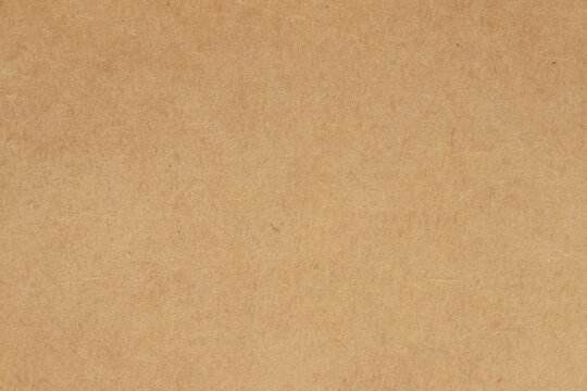 Brown cardboard sheet abstract background, texture of sepia color kraft paper with vintage pattern for design art work.
