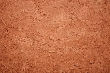 Naklejka premium Top view of red clay soil texture and background. Earthy rustic clay tone creates a natural.