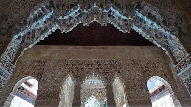 Slow motion view of intricate muqarnas vaulting and carved stucco ornamentation inside the Nasrid Palaces of the Alhambra in Granada, Spain