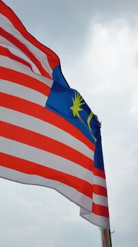 Vertical Close-Up of Malaysian Flag Jalur Gemilang in the Wind