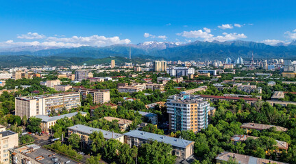 Obraz premium A view from a quadcopter of the central part of Kazakhstan's largest city, Almaty, on a sunny summer evening.