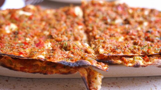 Lahmacun, a traditional Turkish flatbread topped with minced meat, vegetables, and herbs