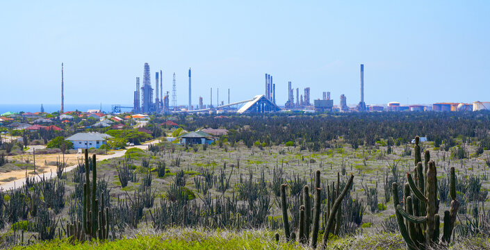 Valero oil refinery industrial complex behind cactus desert landscape in San Nicolas (Sint Nicolaas) in the south of Aruba Island in the Eastern Caribbean