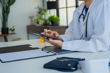 Fototapeta premium Doctor using tablet working with patient