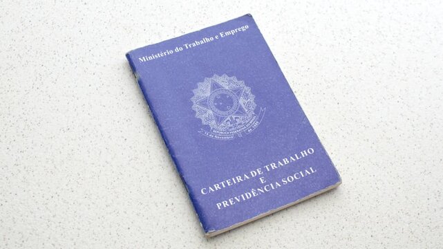 Brazilian Work ID. Unemployment, job, or salary increase. On a clear surface: Employment symbols reflected on the ID, depicting the pursuit of opportunities, laid on an illuminated table.
