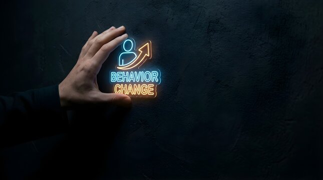 Hand touching glowing neon behavior change sign with upward arrow on dark textured wall background