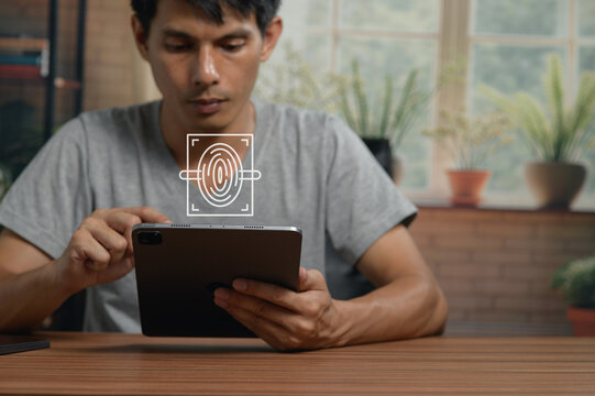 Young Man Using Digital Tablet with Fingerprint Scanner Technology at Home