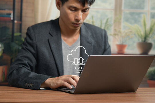 Professional Man Working on Laptop in Modern Office with Cloud Computing Icon