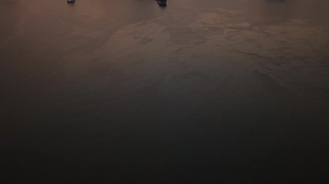 Limestone Karsts And Tranquil Waters Of Ha Long Bay In Vietnam At Sunset - Drone Shot
