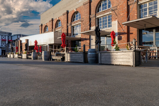 Automotive backplate or road background, featuring traditional brewery behind.with outdoor seating.