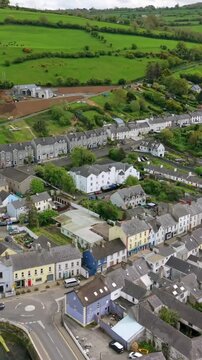 Vertical social ratio aerial video of Glenarm Village, on the Causeway Coastal Route in County Antrim, Northern Ireland in the UK on a sunny day. Produced in 3840x2160 and with Rec709 color.