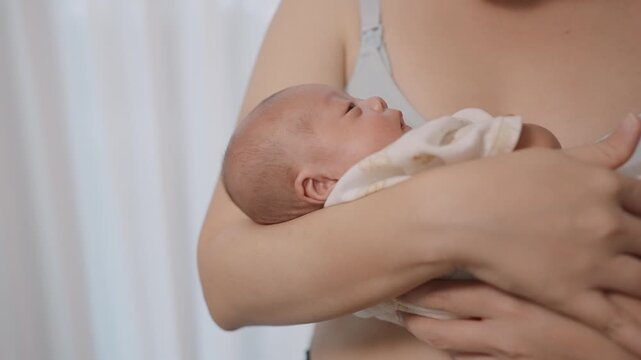 A Mother's Embrace: A mother tenderly cradles her newborn baby, a symbol of unconditional love and the beautiful beginning of life.