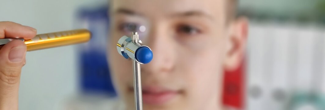 Ophthalmologist examines pupils of patient using flashlight. Work process of ophthalmologist at appointment. visit to eye