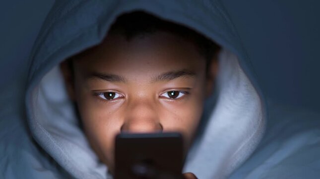 How much screen time is harmful to your child? Black minor with a gadget