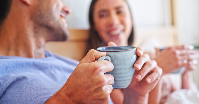 Love, coffee and hands with couple in bedroom of home for connection, morning and support. Commitment, drinking tea and relax with man and woman in bed in apartment for partner, trust and care