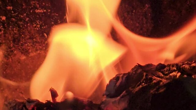 Sacred Hindu Havan Homam Yajna fire ritual being performed during a religious puja ceremony in India. The holy fire burns brightly in a traditional fire altar while devotees offer prayers