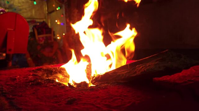 Sacred Hindu Havan Homam Yajna fire ritual being performed during a religious puja ceremony in India. The holy fire burns brightly in a traditional fire altar while devotees offer prayers