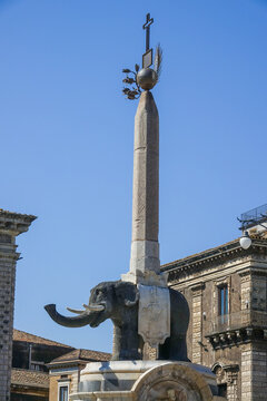 View of the historic Elephant Fountain, a black lava stone sculpture topped with an Egyptian obelisk, situated in the city square of Catania, Sicily, Italy.