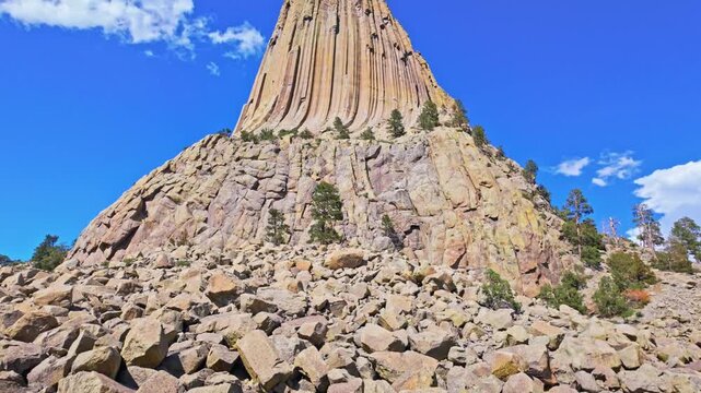 Close up view of Devils Tower National Monument rising above the surrounding forest in Wyoming