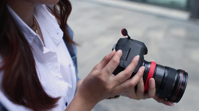 Photographer Installing SD Card Into Camera Outdoors
