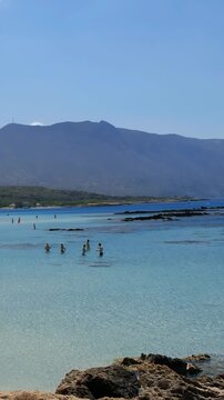 Vertical video of Elafonissi Beach with turquoise shallow water. Crete. Greece
