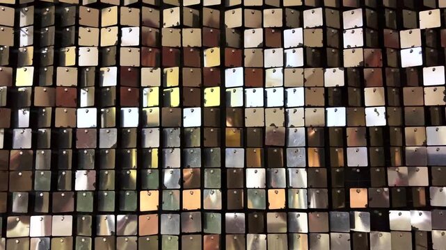 Abstract light reflections shimmering from decorative metallic ornaments, creating sparkling patterns, glittering highlights and a festive atmospheric background