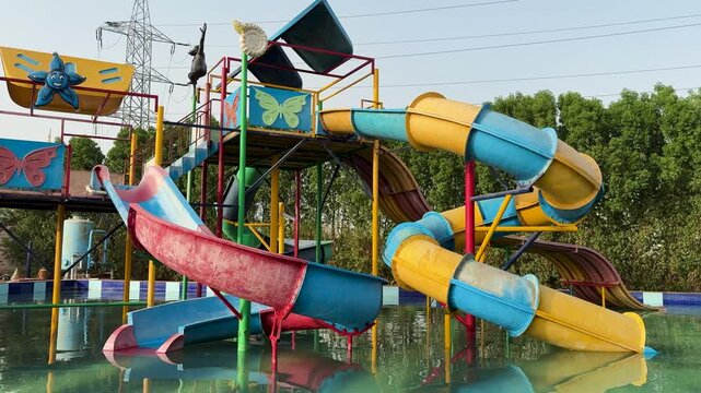 family friendly water park structure with multiple slides and splash zone under sunny sky