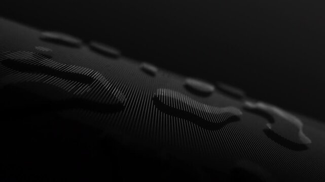 Droplets rest on a dark, textured surface. Light glints off each bead with quiet precision. Shadowy depths frame the surface's intricate grain. Minimalist mood evokes calm, mystery, or introspection