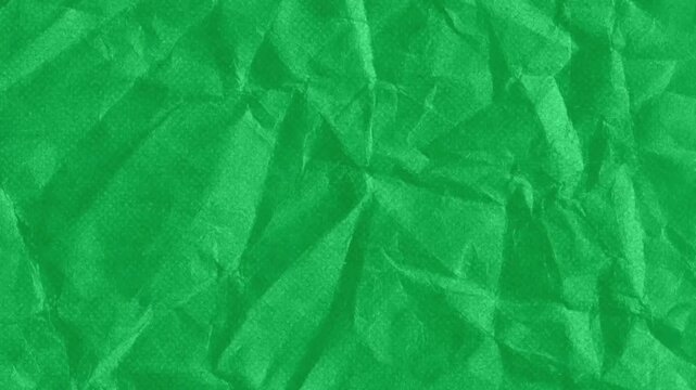 Textured green crumpled paper background with subtle stop motion animation movement and wrinkles

