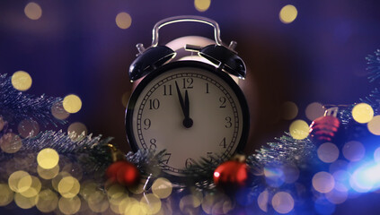 Christmas gifts, fir branches and alarm clock on wooden table. Boxing day
