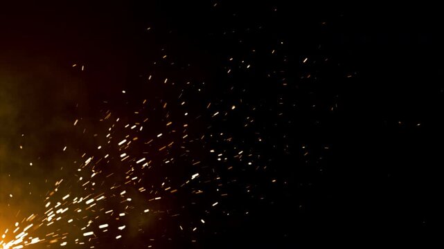 Sparks fly against a deep black night sky. Bright, sharp flashes light the darkness. Fires ignite metal with force and beauty. Ideal for dynamic energy or industrial themes