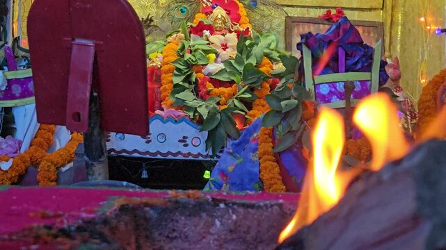 Sacred Hindu Havan Homam Yajna fire ritual being performed during a religious puja ceremony in India. The holy fire burns brightly in a traditional fire altar while devotees offer prayers