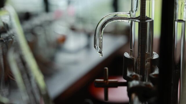 Distillation laboratory glass equipment alcohol liquid drop transparent science chemistry precise measurement process tool experiment clean technology research apparatus fluid condensation closeup
