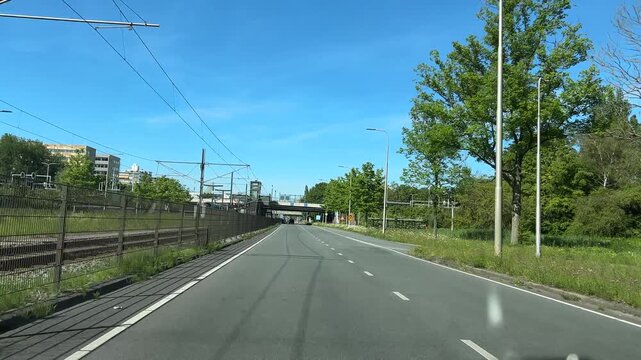 Amsterdam suburbs, Amstelveen, Suburban Dutch Road with Directional Signs and Tram Line